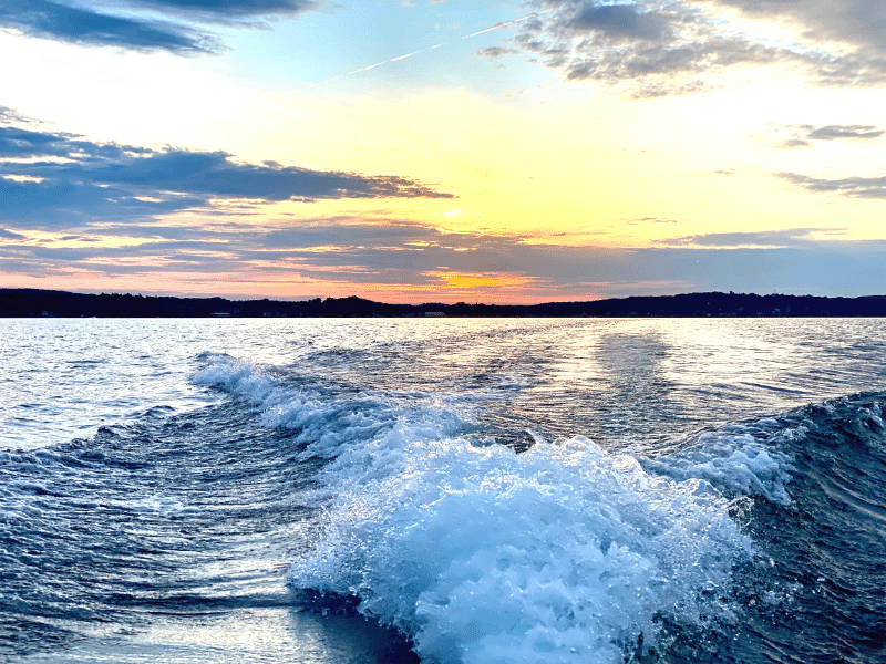 boating safety on the crystal coast, sunset and the wake of a boat
