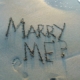 Marry me? written in sand at a beach on the Crystal Coast
