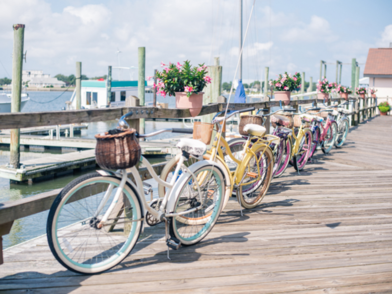 an assortment of pastel colored bikes with baskets along the beaufort nc waterfront