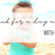 banner image of an adorable baby on the beach