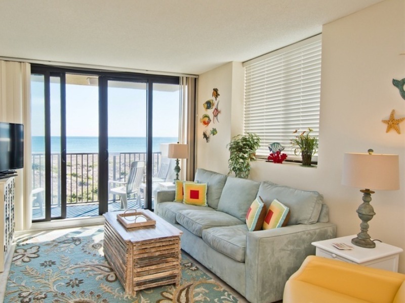 Photo of living room overlooking the beach at one of our Atlantic Beach vacation rentals