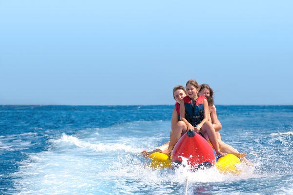 Girls riding a banana boat on the crystal coast