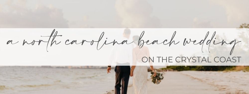 Newlyweds walk hand-in-hand along the shoreline of an idyllic beach on the Crystal Coast.