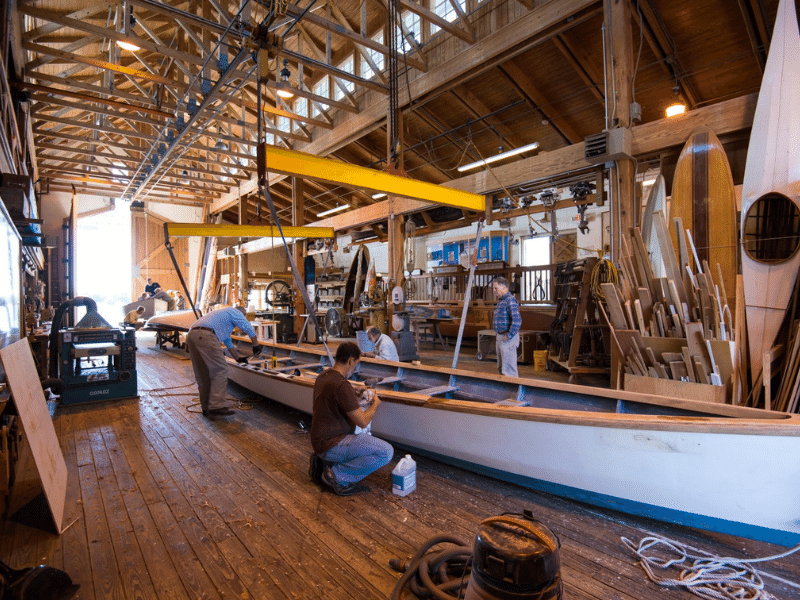 men working on a boat at the Harvey W. Smith Watercraft Center